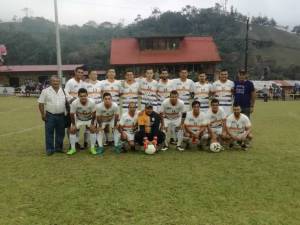 Equipo de futbol de uniforme blanco posando en cancha